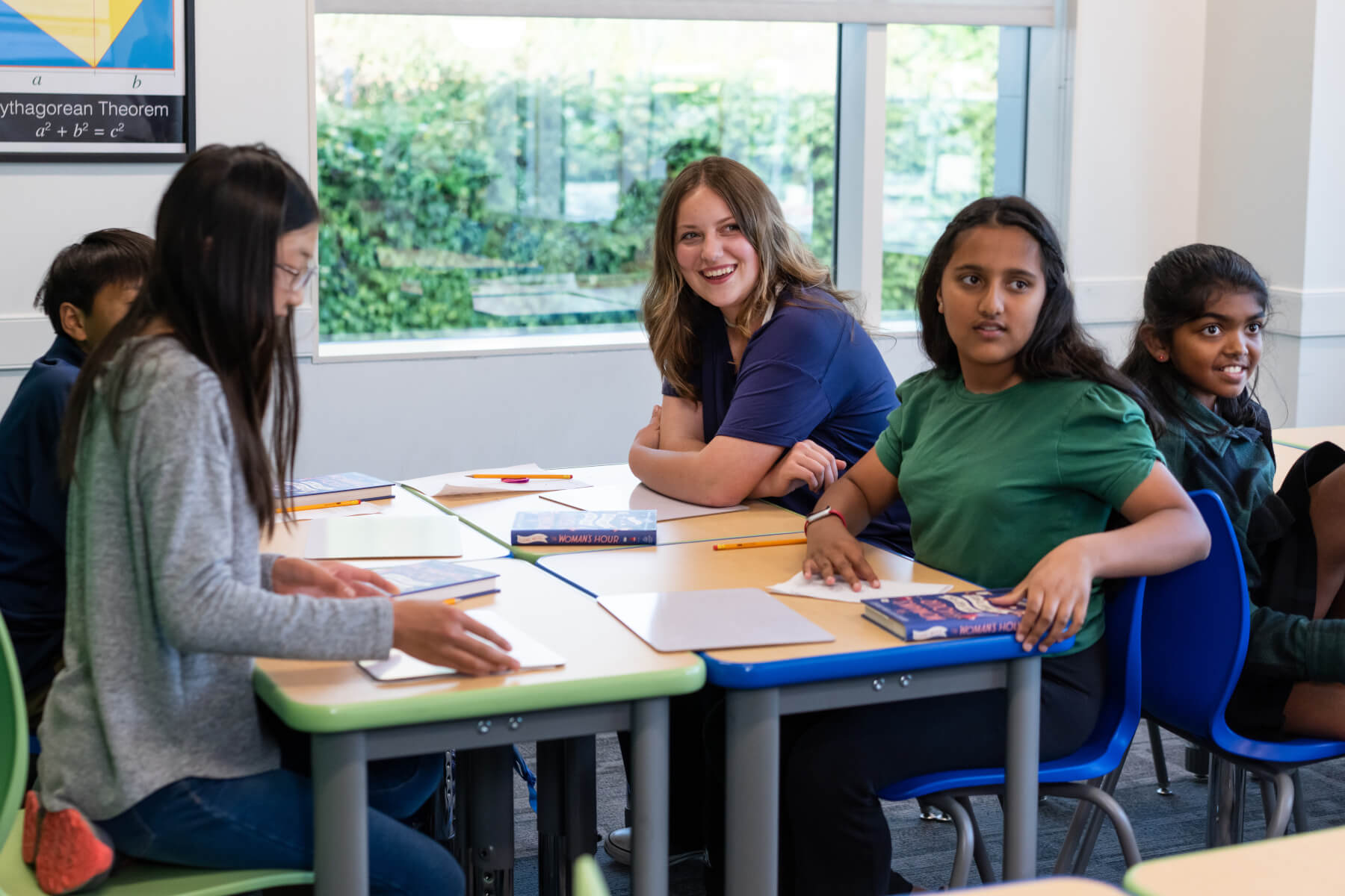 Students at classroom table doing an assignment together